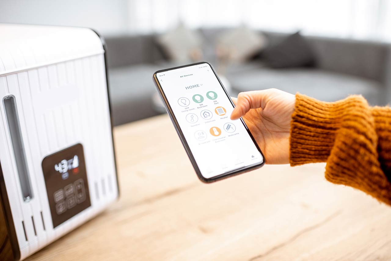 Close-up on a smart phone with launched home assistant application, controlling air humidifier at home