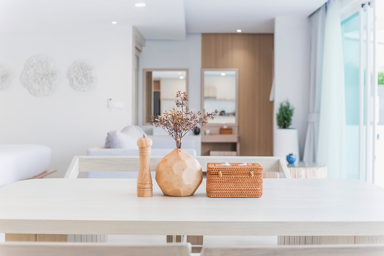Modern kitchen interior, wooden table, blurred background showing the atmosphere of the room, clean design, home cooking area, neutral colors, natural light stock photo